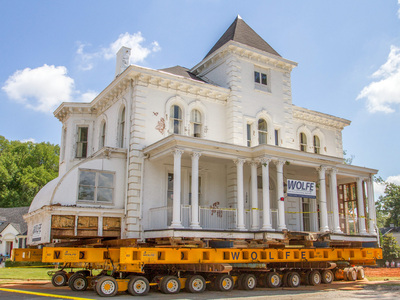 A large white historic house is steered into place using the Buckingham SmartSteer® System