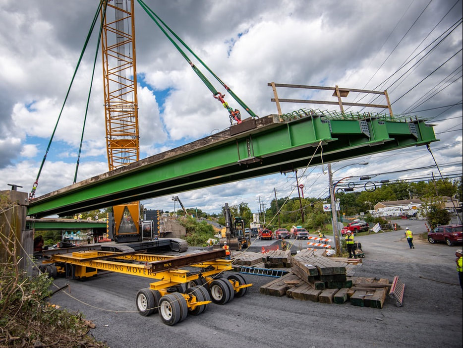 Buckingham Customizable Self-Propelled Transporter is loaded with a prefabricated bridge section for an accelerated bridge replacement project