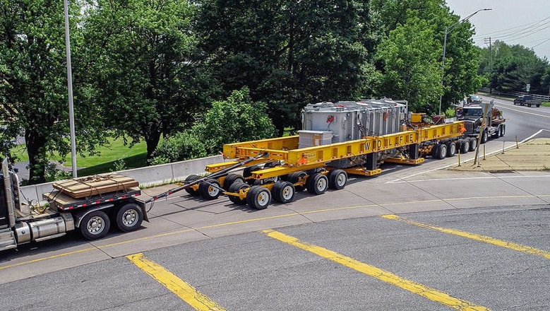 Buckingham 16-Axle Dual Lane Transporter with transformer and tow and push trucks
