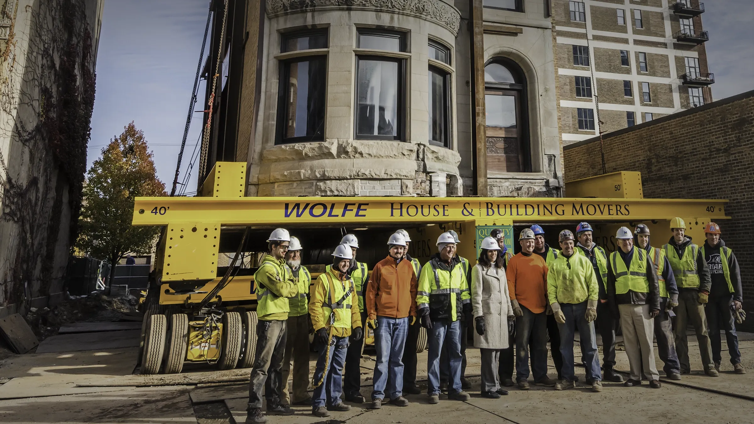 People lined up in front of a house on Buckingham dollies